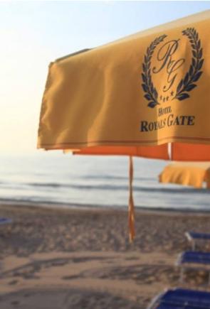 Ombrelloni gialli del Hotel Royals Gate su una spiaggia al tramonto.